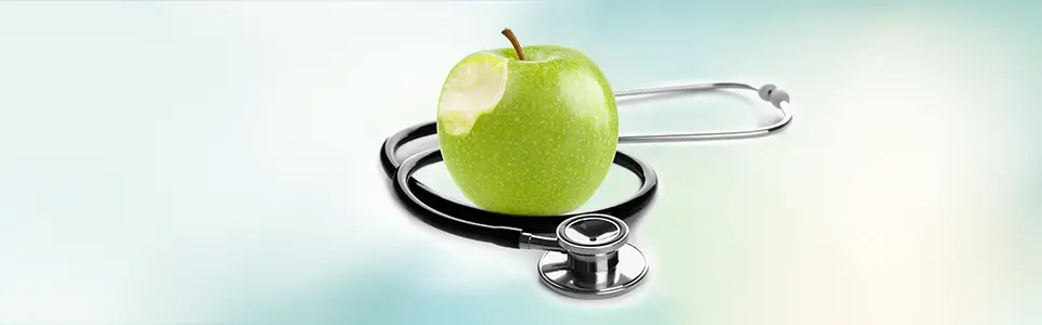 An stethoscope wrapped around an apple